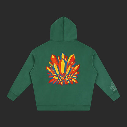 4iir Crystal Lava hoodie in forest green with a vibrant red and yellow crystal graphic on the back.