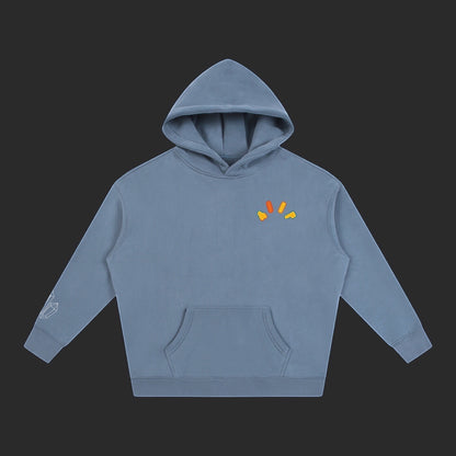 4iir Crystal Lava hoodie in dusty blue with a small colorful chest graphic and crystal sleeve detail.