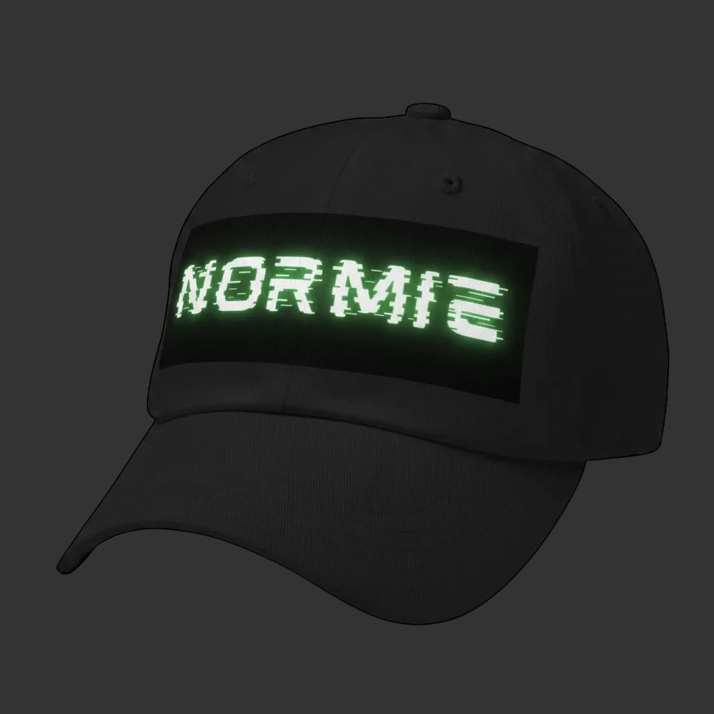 4iir Normie cap in black chino cotton twill with a green glitch-effect NORMIE text graphic on the front panel.