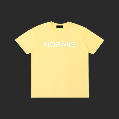 4iir Normie T-shirt in pastel yellow cotton with white glitch-effect text graphic on the chest.