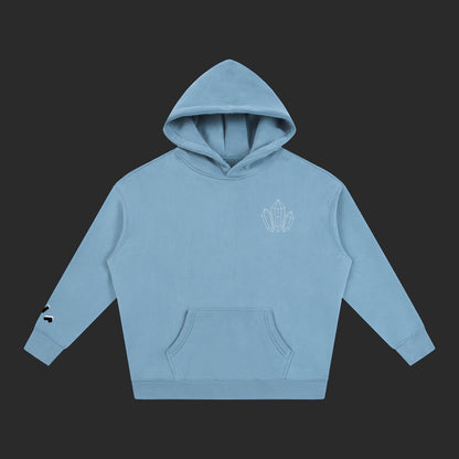 4iir Revenge hoodie in dusty blue with a small white crystal graphic on the chest and sleeve detail.
