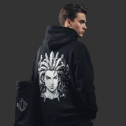4iir Revenge hoodie in black with a white Medusa graphic on the back, worn by a man in a studio setting.