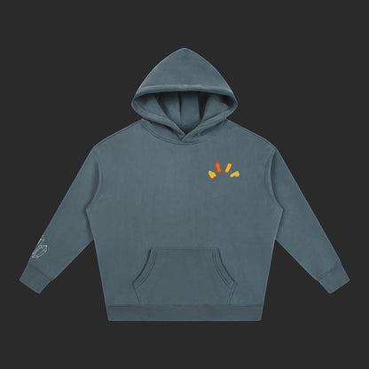4iir Crystal Lava hoodie in slate blue with a small orange and yellow graphic on the chest and crystal sleeve print.